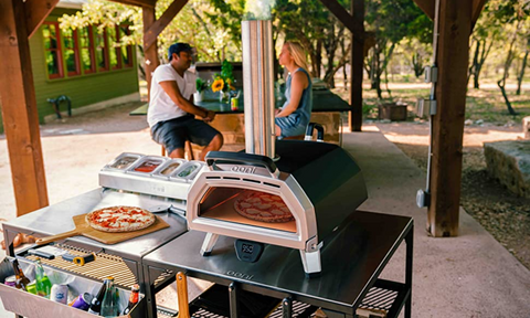 Ooni Karu 16 cooking pizza in outdoor setting