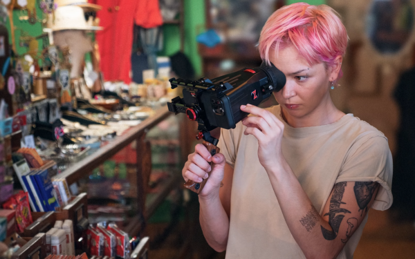 Person filming products at a store near the checkout with their smartphone