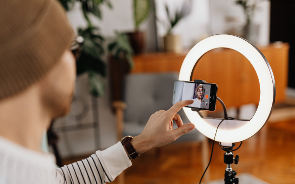 Person filming themselves in a living room with their smartphone.