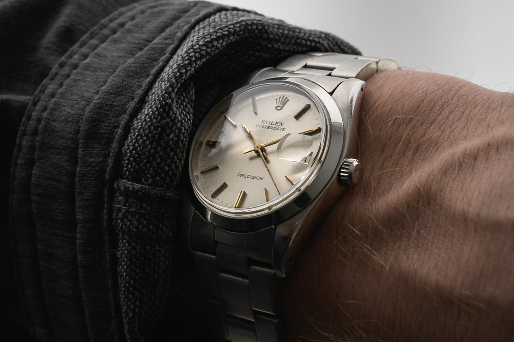 Wristshot of a vintage 1960s Rolex Oysterdate 9964 gold on silver