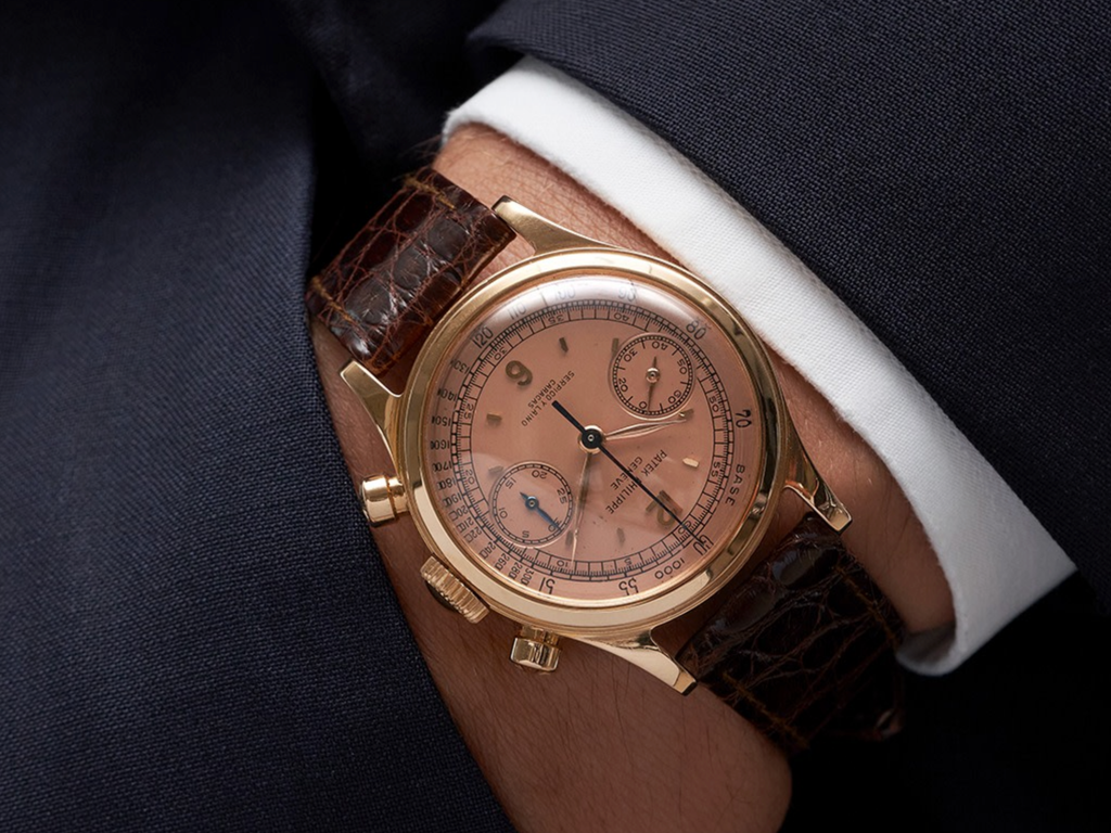 A rare pink on pink Patek Philippe ref. 1463 Tasti Tondi chronograph from the 1950s - shown on the wrist of a man in a suit