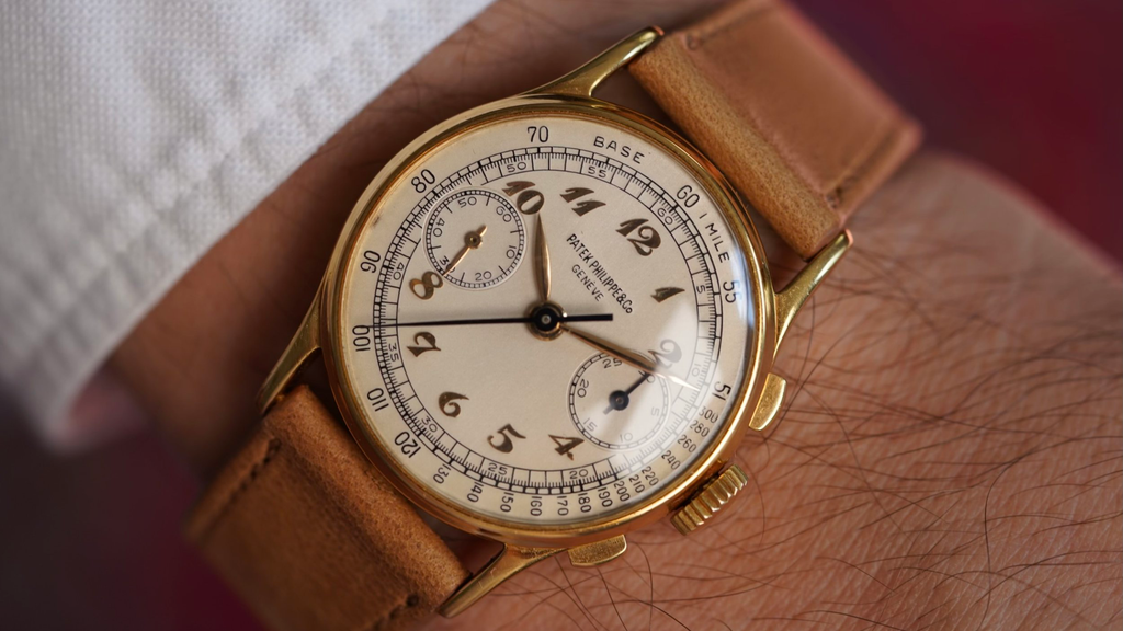 wrist shot of a vintage Patek Philippe ref. 130 chronograph in gold