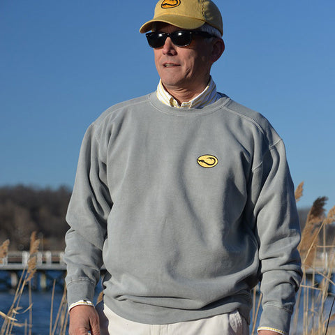 man in Hook Life fishing sweatshirt at the harbor