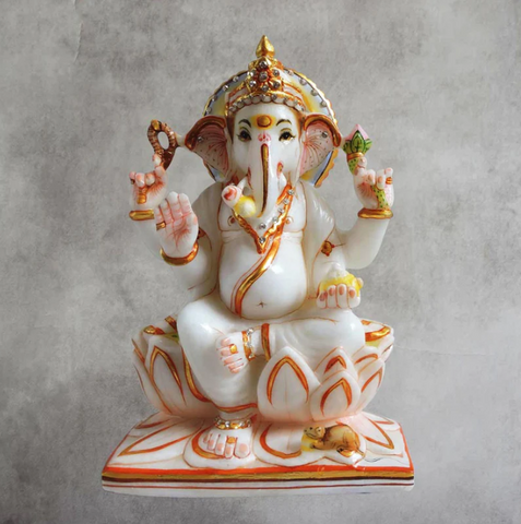 A Ganesha idol made using marble sitting on a lotus