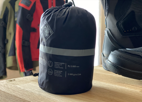 waterproof motorcycle jacket pack on the shelf in Moto Lounge