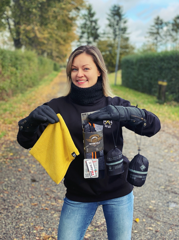 a woman holding some motorcycle products 