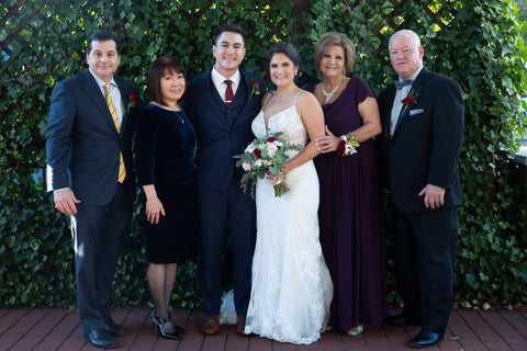 Image of the bride and groom with their parents on their wedding day