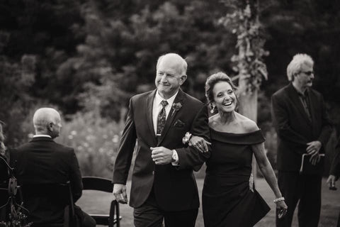Mother and father of the bride walking down the aisle at a wedding