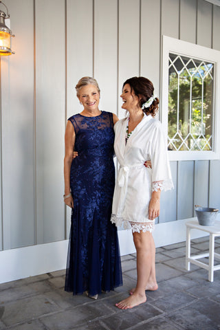 Mother of the bride and bride smiling getting ready for wedding