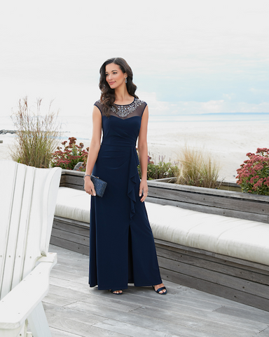 Woman outdoors in navy blue evening gown with crystal details on top