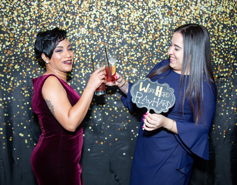 Image of two ladies in elegant evening dresses at a festive party