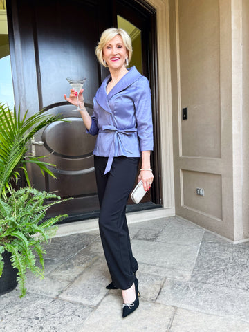 Woman outside in beautiful evening separates with a drink ready for a formal occasion