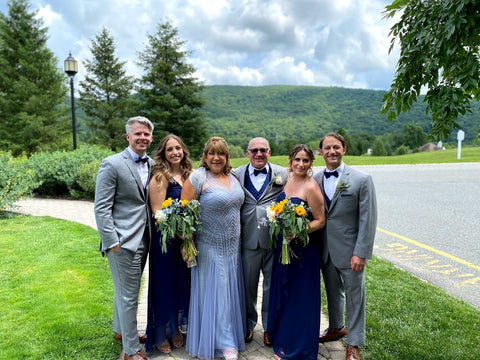 Mother of the Bride and Mother of the Groom with wedding party outdoors