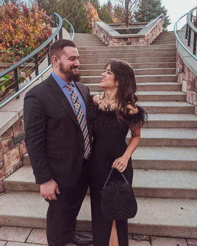 Couple standing outside next to stairs in elegant evening wear