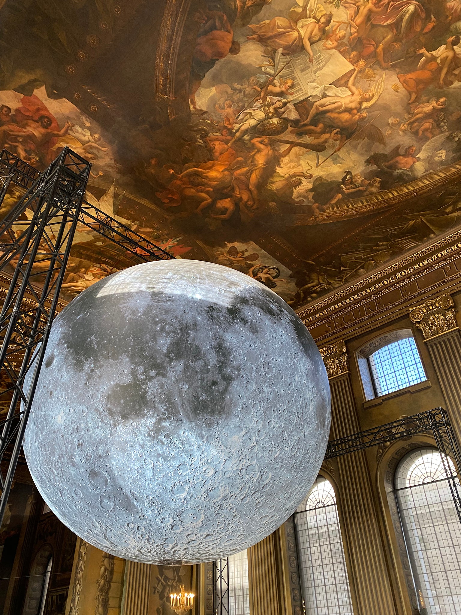 A close up of the moon against the painted ceiling