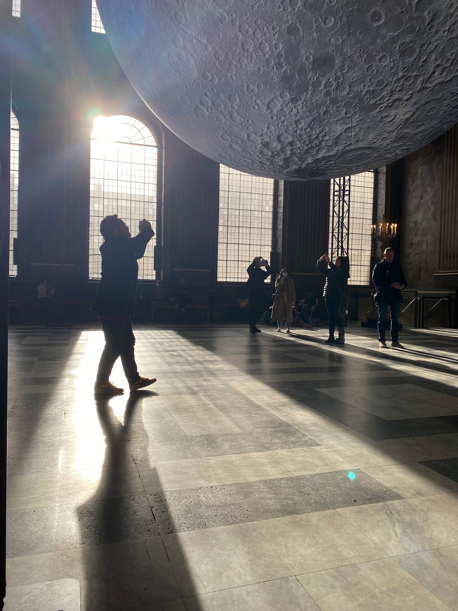 Chris silhouetted against the sun streaming in through the windows