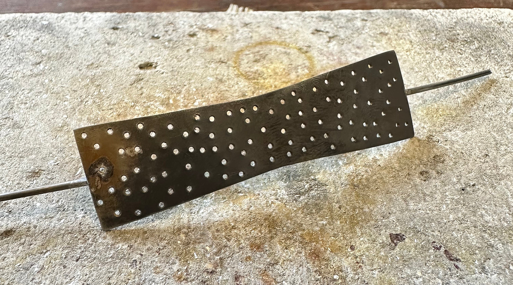 Having drilled all the dots in the silver