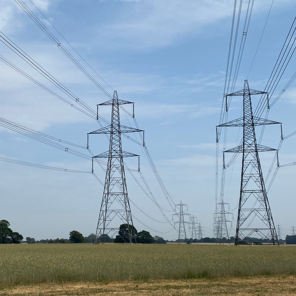 Pylons going into the distance across fields