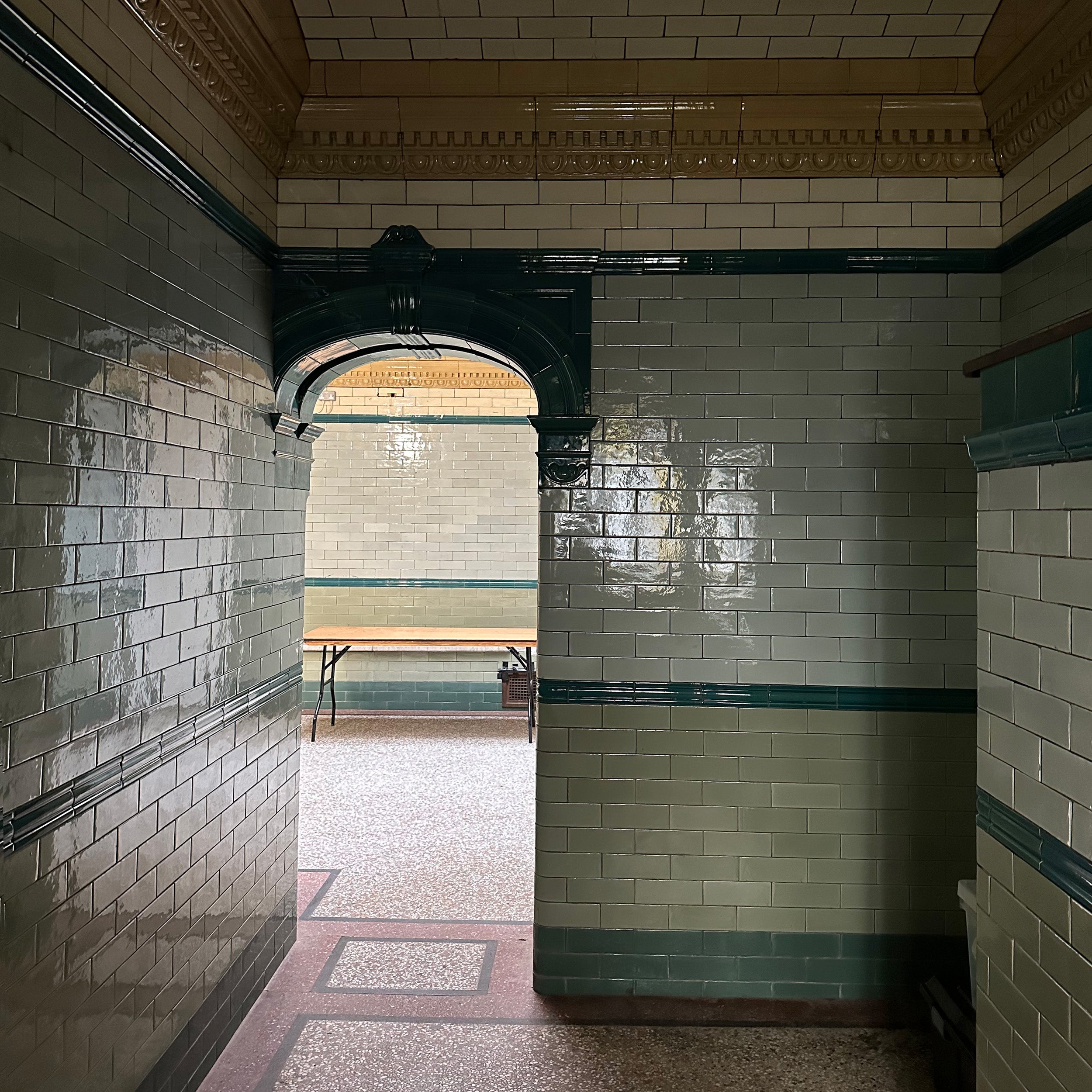 A shadowy view into a tile room