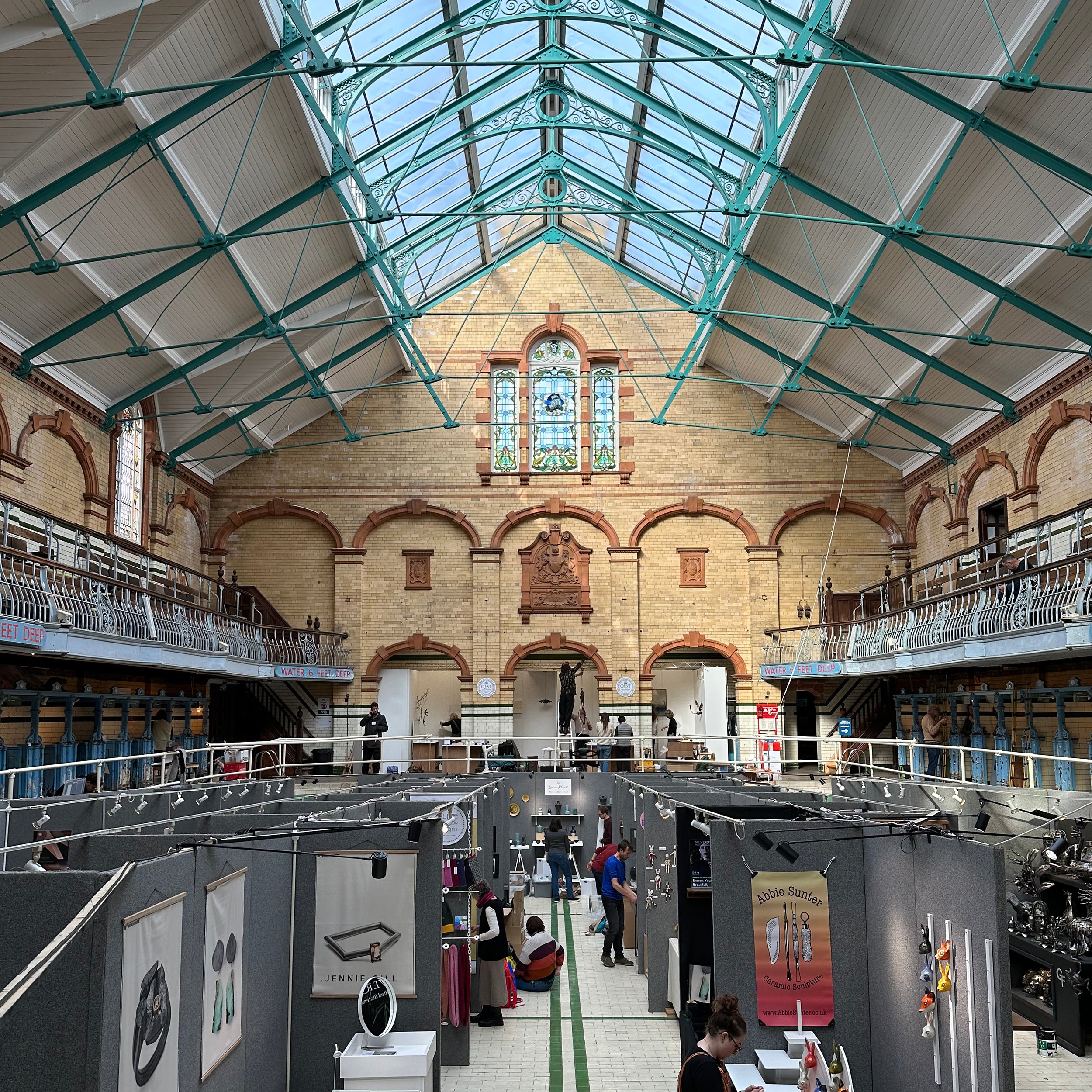 A view down the centre of a swimming pool with stands set up