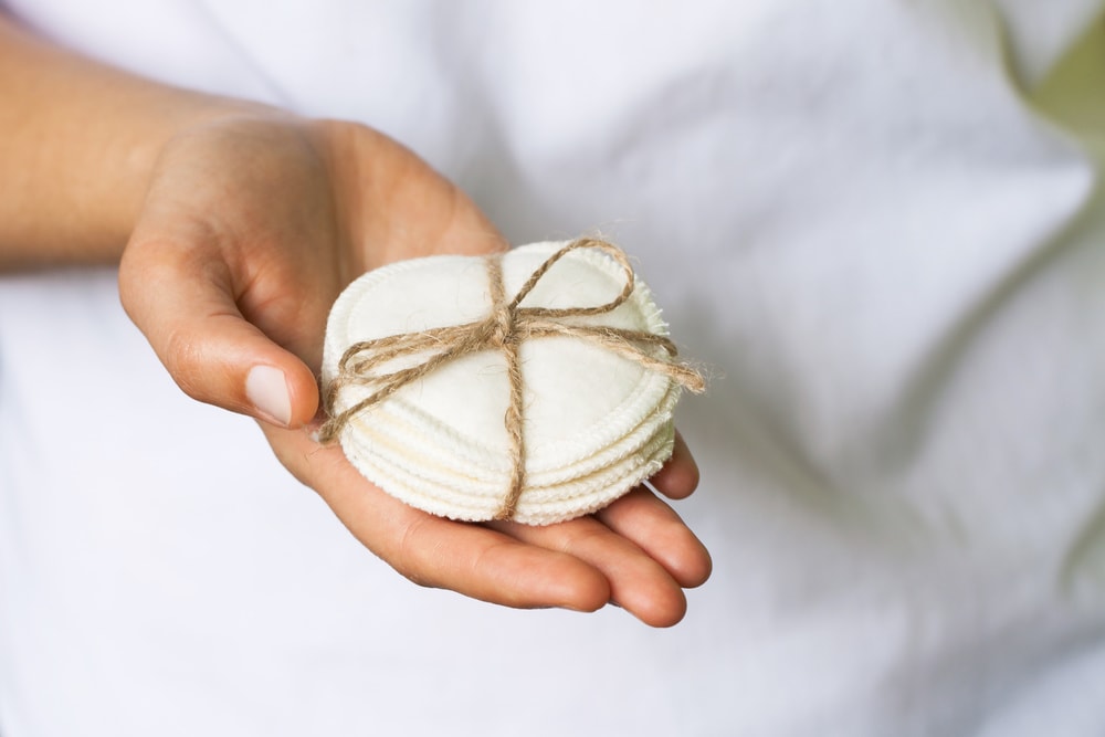 Reusable cotton pads in a womans hand