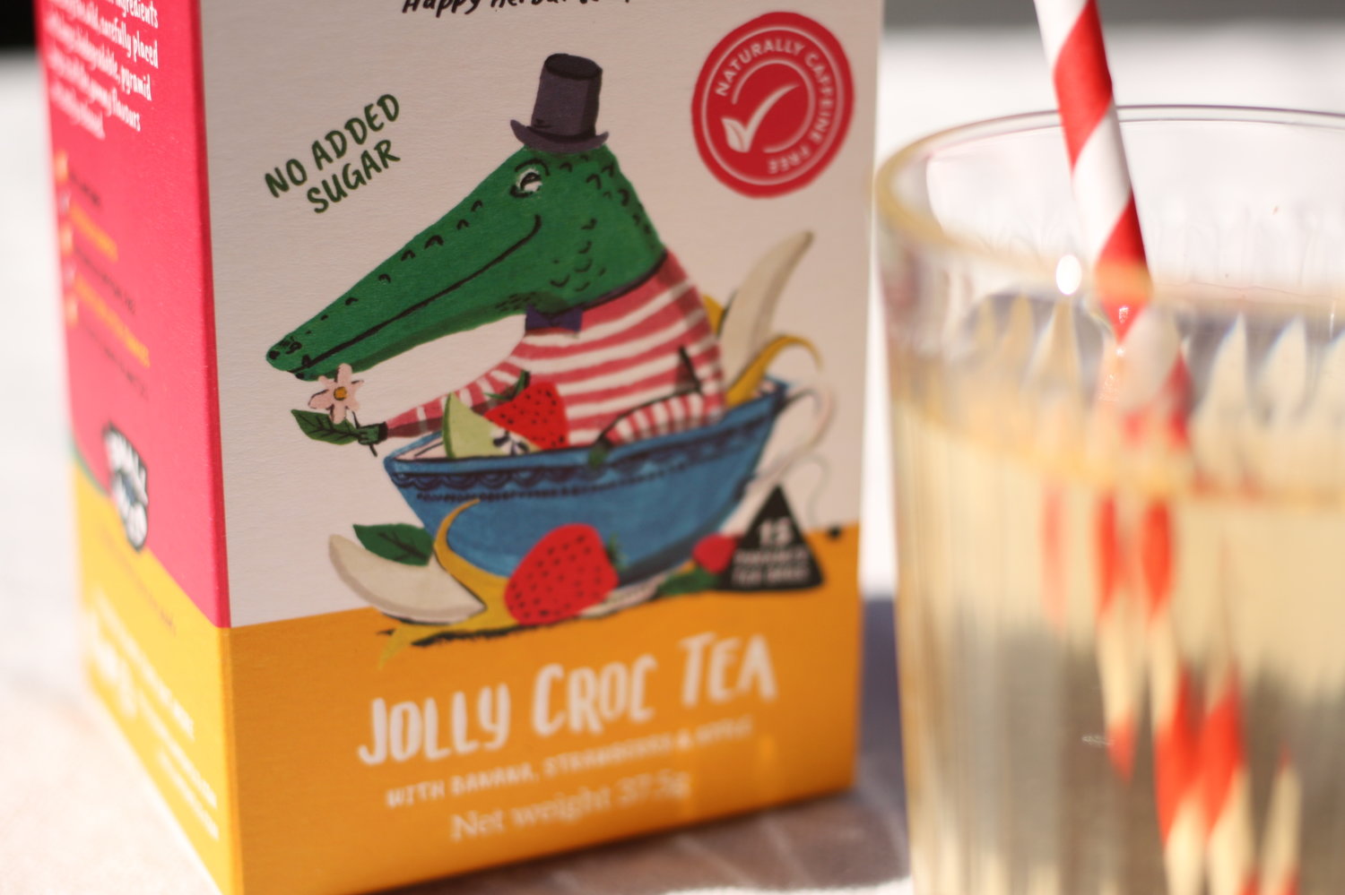 Jolly Croc fruit iced tea with banana and strawberry in glass with straw
