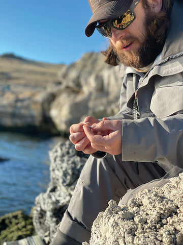 MILES ZIMMERMAN OF TROUT CREEK OUTFITTERS PREPARES A FLY FOR  PYRAMID LAKE, PHOTO BY SCOTT KEITH, COURTESY TROUT CREEK OUTFITTERS