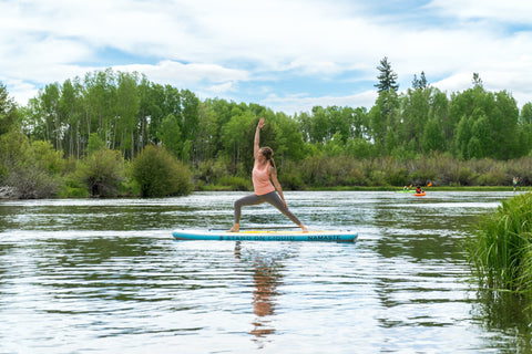Women on Stand on Liquid Namaste Inflatable stand up paddleboard