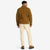 General back model shot of Topo Designs Men's Sherpa Jacket in "Dark Khaki" brown showing sherpa fleece side.