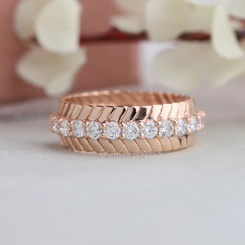 VS clarity round cut diamond fancy and modern wedding band for women made with rose gold and round prong settings.