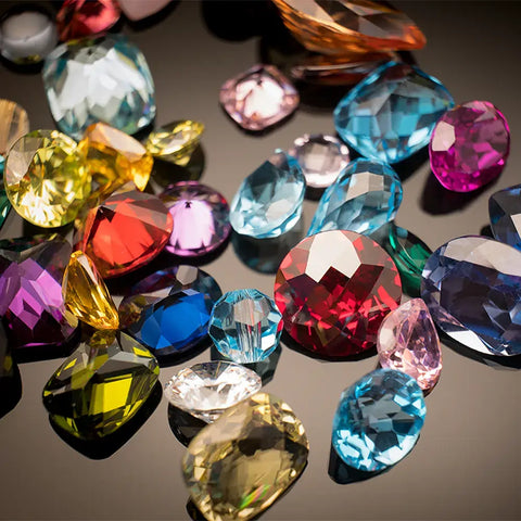 Colored alternative gemstones to be chosen in women's ring made with gold and intricate designs.