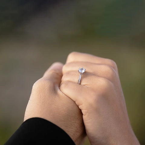 The couple wears an ethical diamond promise ring on the finger as the promise of a green environment and better human society atmosphere in contrast to blood diamond.