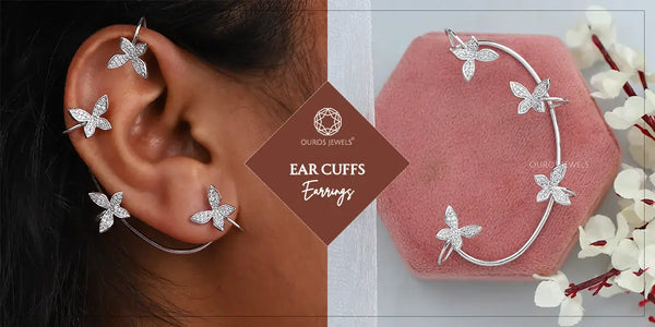 [Close-up of a woman's ear wearing butterfly-shaped diamond ear cuffs, with a single ear cuff displayed on a pink surface]-[ouros jewels]