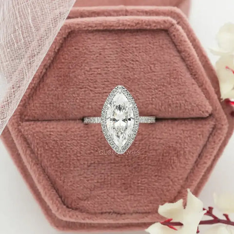 Marquise shaped diamond halo engagement ring made with the white gold and shared surface prong setting containing a accent diamonds.