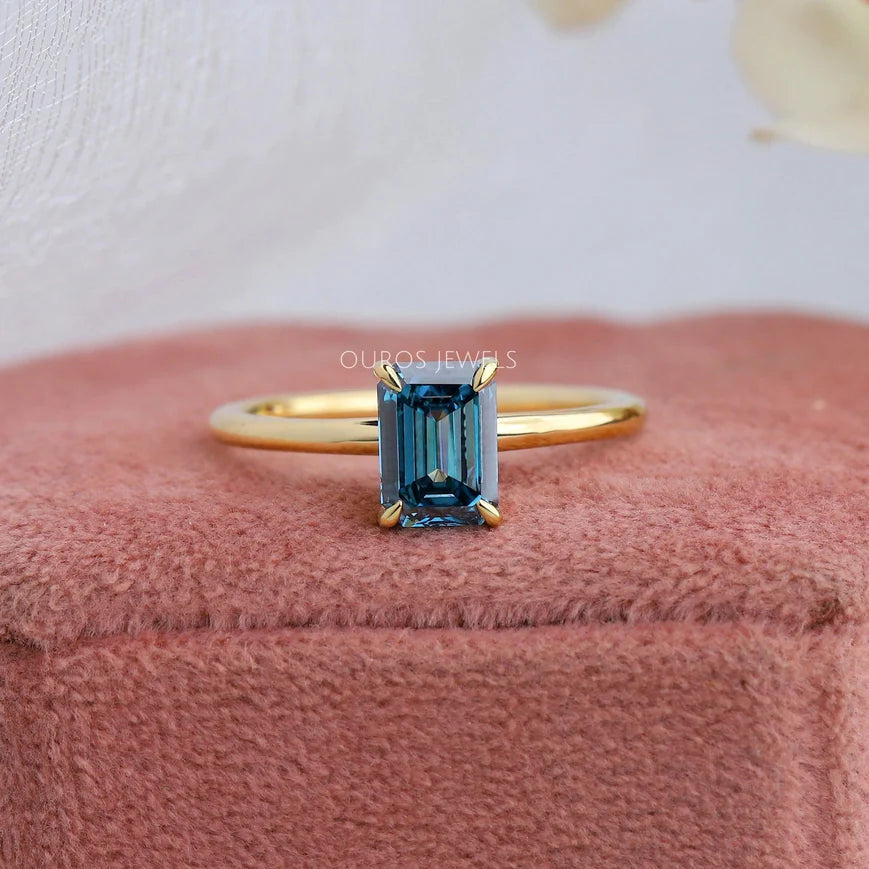 1.40 carat weighted emerald cut vivid blue lab-grown diamond solitaire engagement ring with VS clarity and 18KT yellow gold
