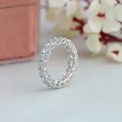 Exquisite white gold eternity wedding ring featuring a continuous array of brilliant oval diamonds in a shared prong setting. This timeless design symbolizes everlasting love and commitment,