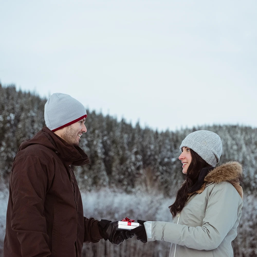 Woman gifted with a diamond ring by a man as wedding proposal on the snow mountain