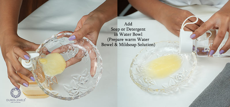 [ Hands preparing a mild soap solution in a crystal bowl for jewelry cleaning, with soap being added to warm water in the bowl]-[ouros jewels]