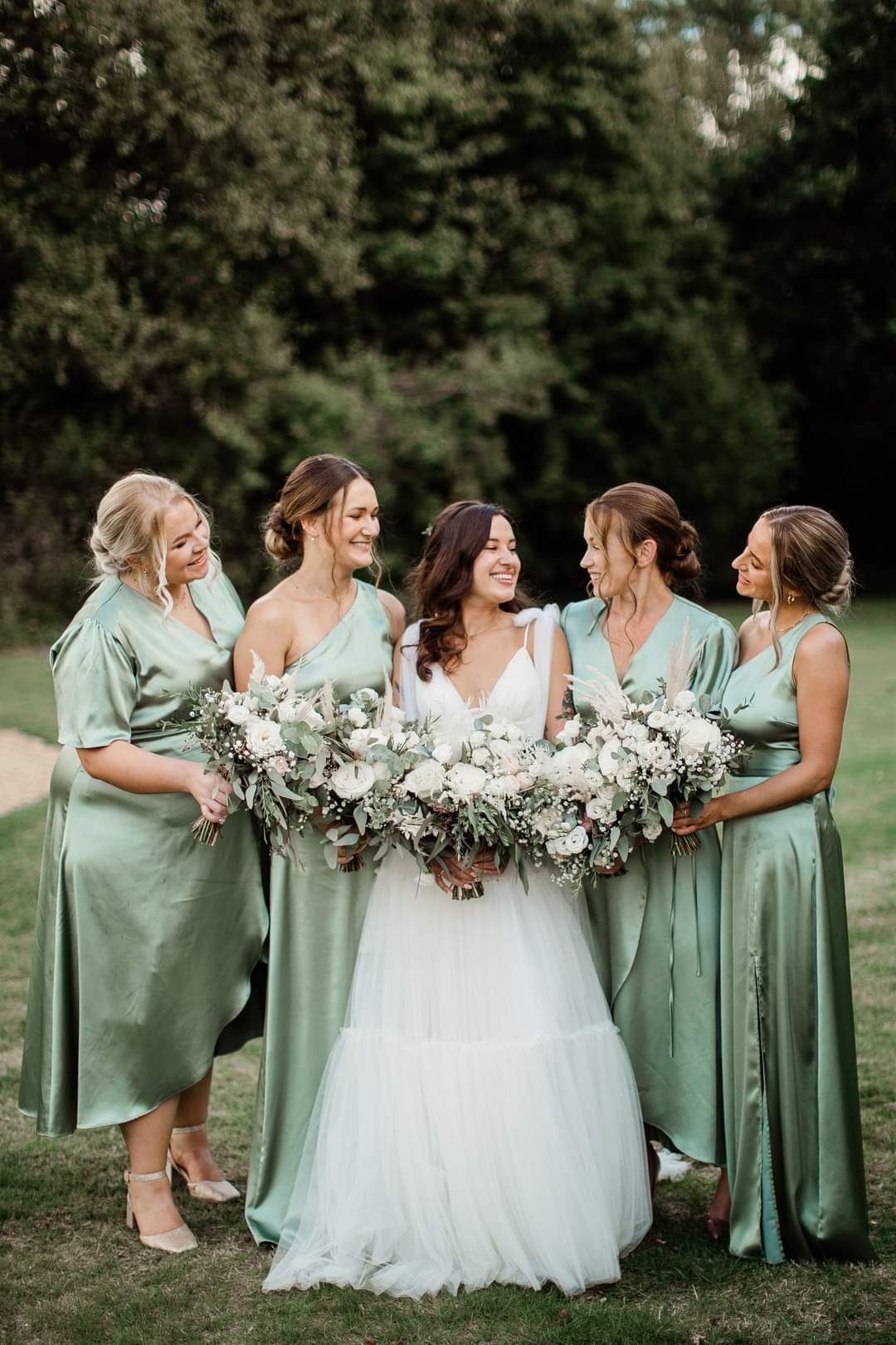 Sage green bridesmaids dresses - wrap style and one shoulder satin style.
