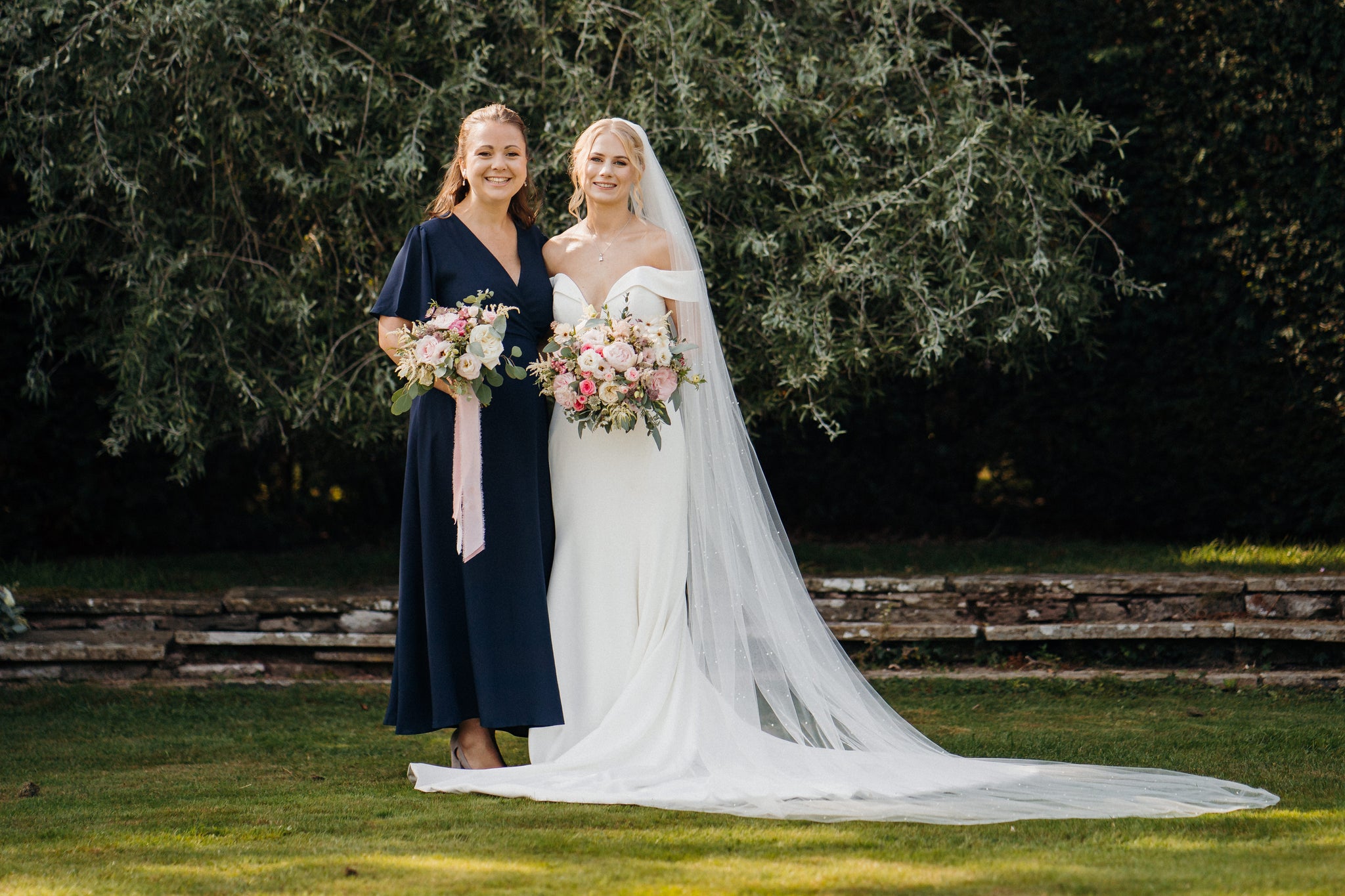 Bridesmaids in a mix of styles in ink navy blue.