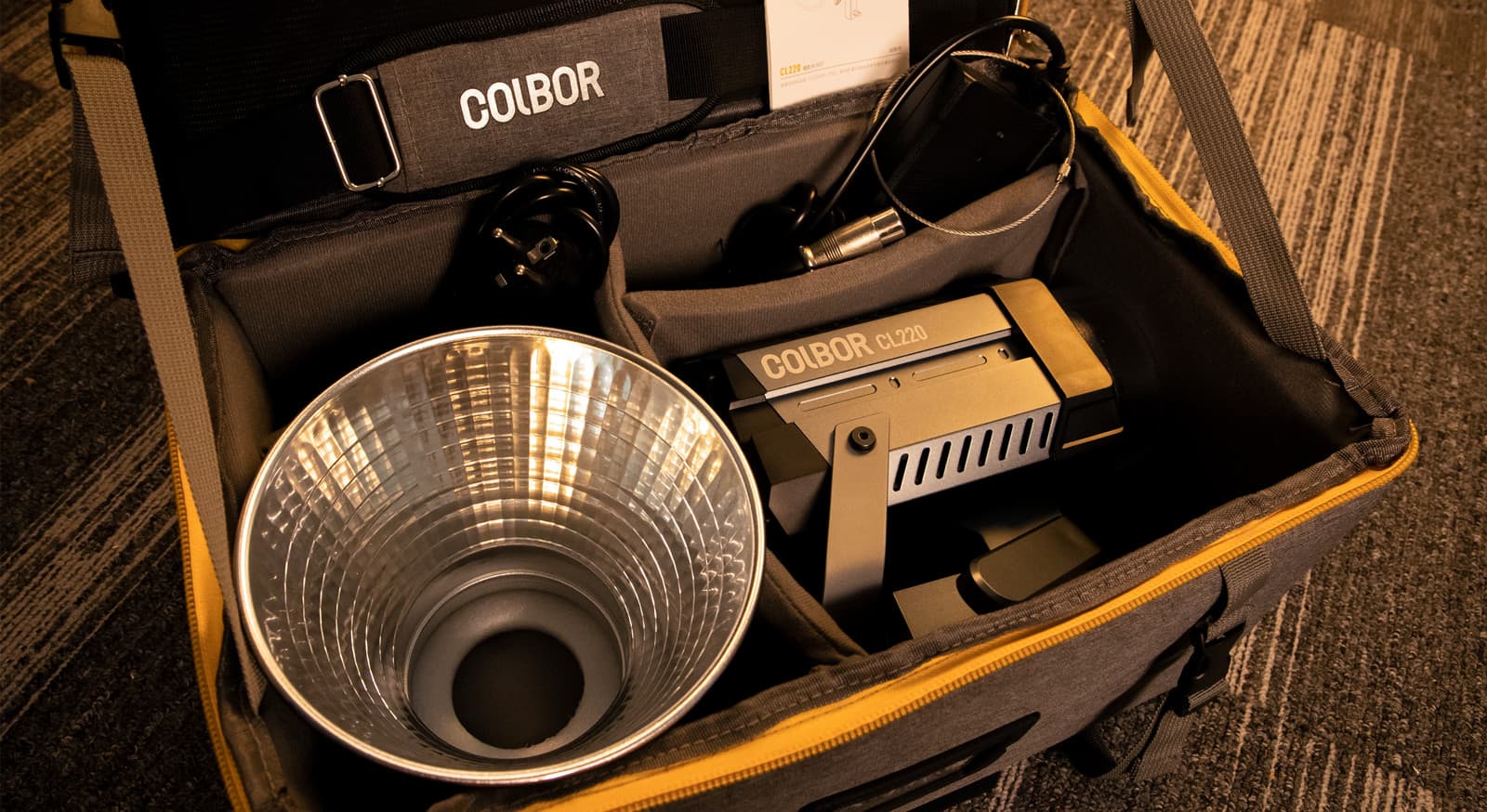 COLBOR CL220 includes the light itself, a reflector, a power adapter, and a NATO accessory in its carrying bag.