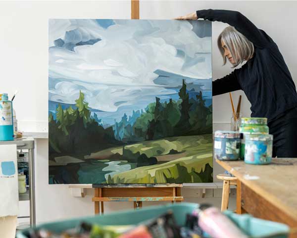 Artist Susannah Bleasby with Hillside original painting in studio