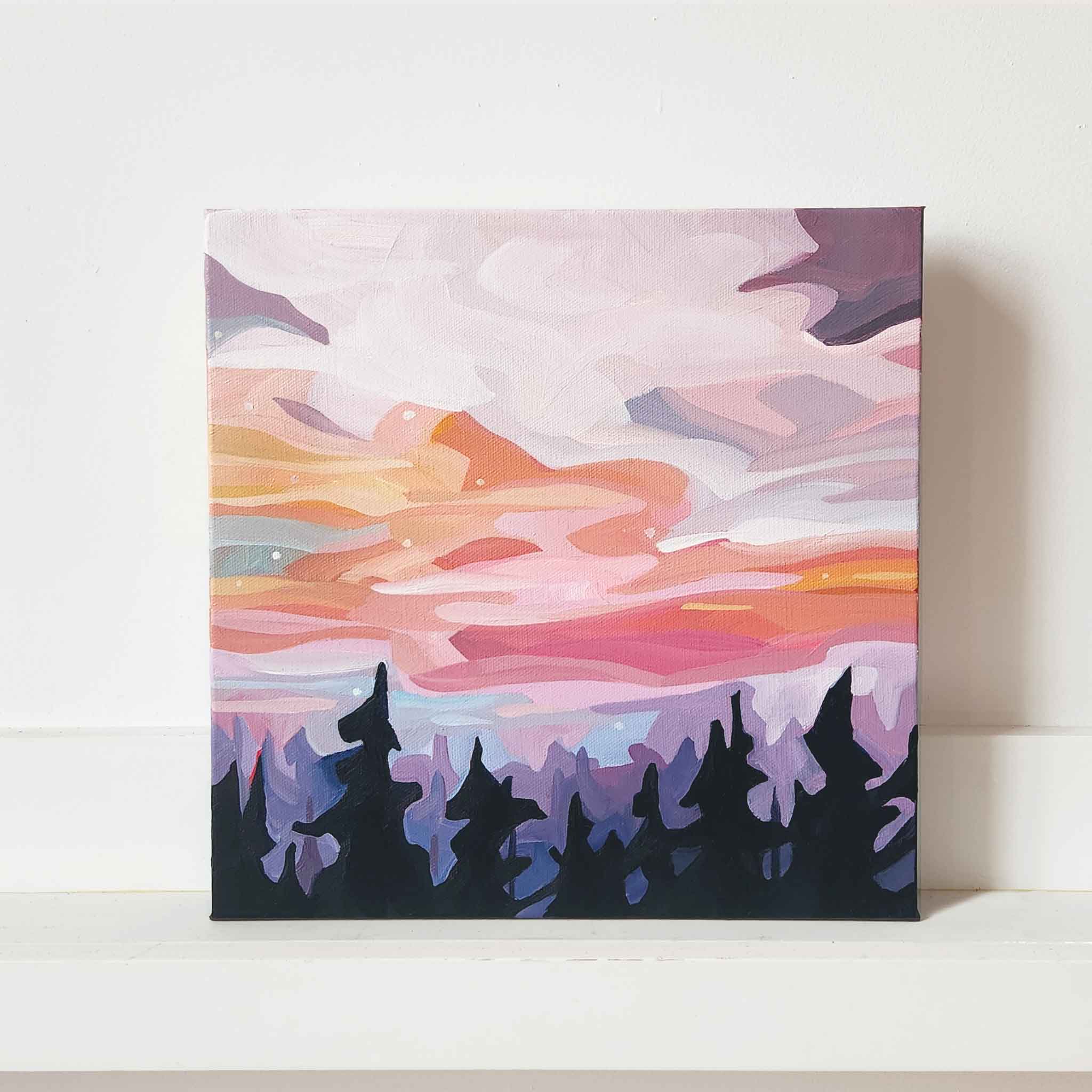 peach and mauve sunset sky painting over forest