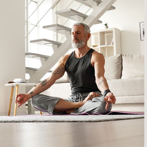 Older man doing yoga and meditation