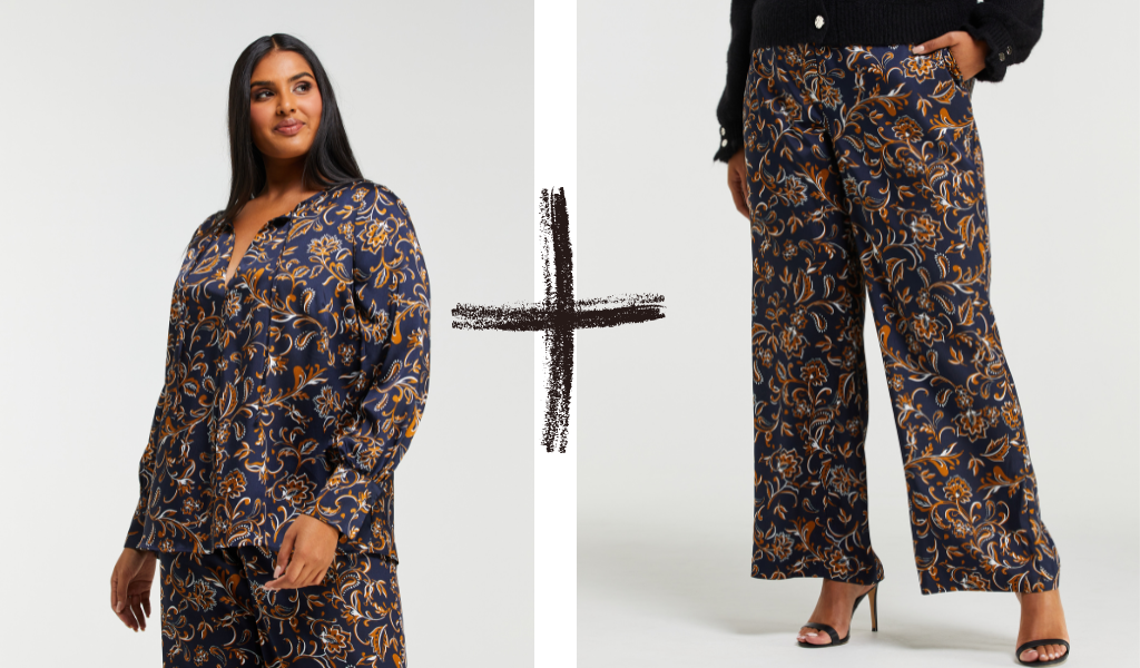 Pictured: Plus sixe model wears the Capitano Top and Pant. The garments are made from a silky material and feature a navy and tan paisley pattern