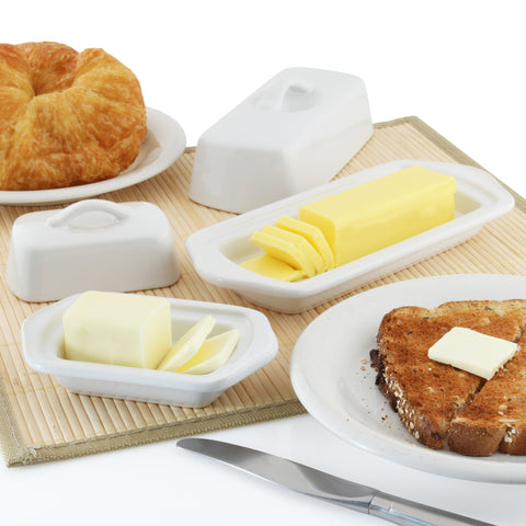 set of two white butter dishes with butter and bread