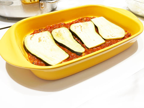 add layer of eggplant for lasagna in marigold ceramic baker