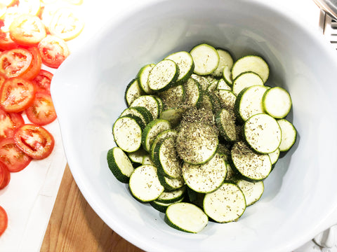 add zucchini to mixing bowl and add seasoning for tomato and zucchini bake recipe