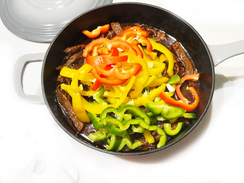 bell peppers and beef in cast iron skillet