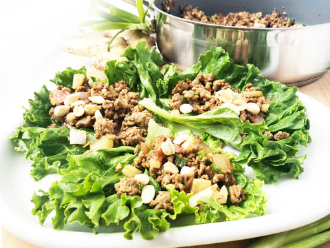 Plate of lettuce wraps with peanuts on top and ID21 coated saute 